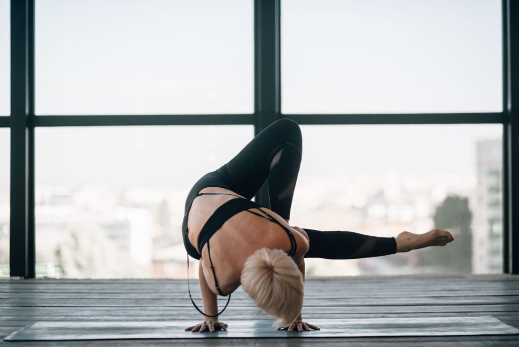 woman-in-black-sports-bra-and-black-leggings-doing-yoga-vv9zlasxfto